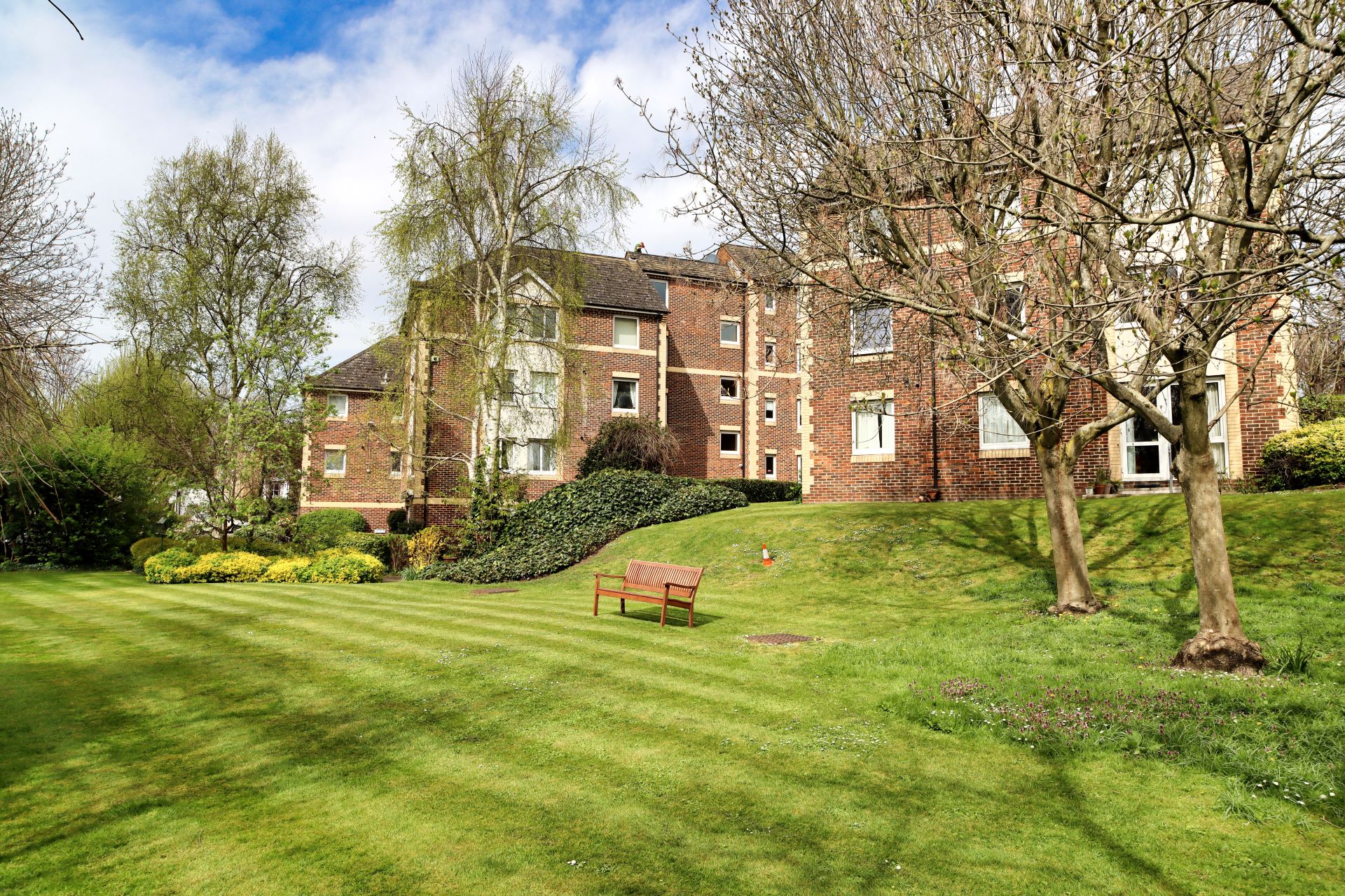 Beautiful summers day with views of the communal grounds at homewalk house sydenham se26 looking at the rear of homewalk house an assisted living complex