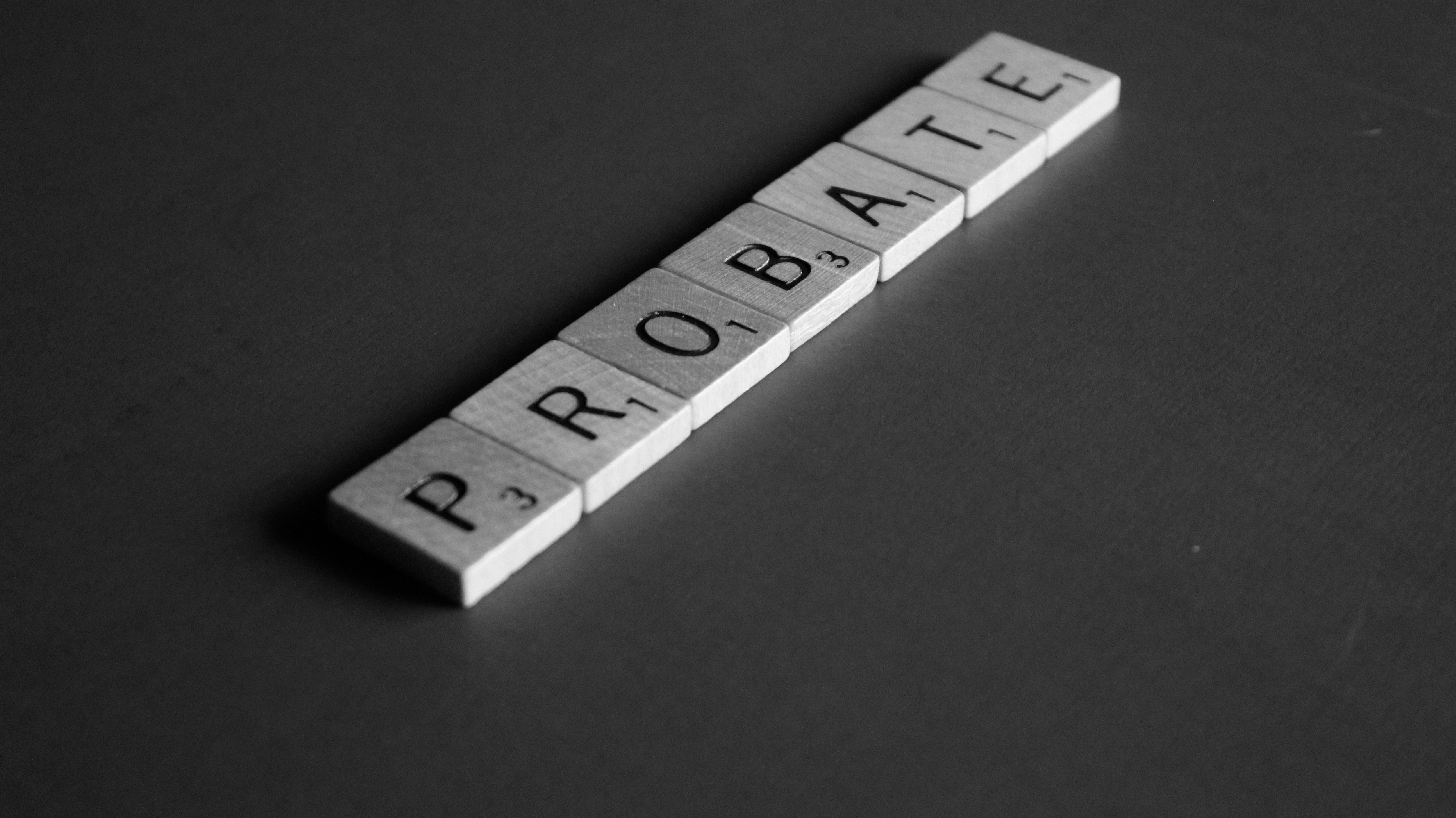 Close-up of wooden Scrabble-style tiles spelling out the word "PROBATE" against a dark grey surface. This symbolic image represents probate property sales, inheritance, and estate management, making it highly relevant for SEO on topics such as probate valuations, probate property sales in Orpington, Bromley, Beckenham, and South East Londo
