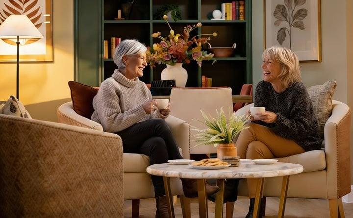 Assisted living lifestyle, to retired friends sharing a friendly chat over a cup of tea.