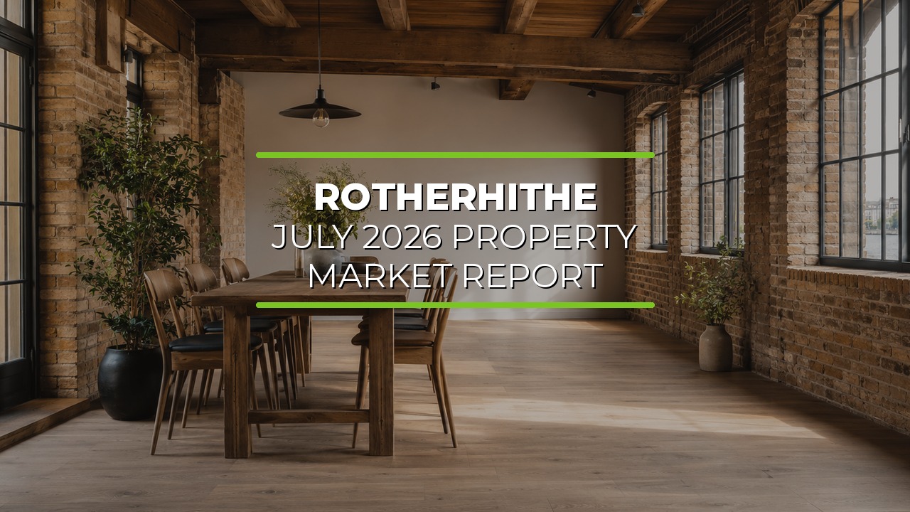 Modern dining area with exposed brick walls, large industrial-style windows, and wooden beams on the ceiling. Wooden dining table with chairs sits at the center, surrounded by potted plants adding greenery. Natural light fills the space. Overlaid text reads ‘Rotherhithe July 2026 Property Market Report.’