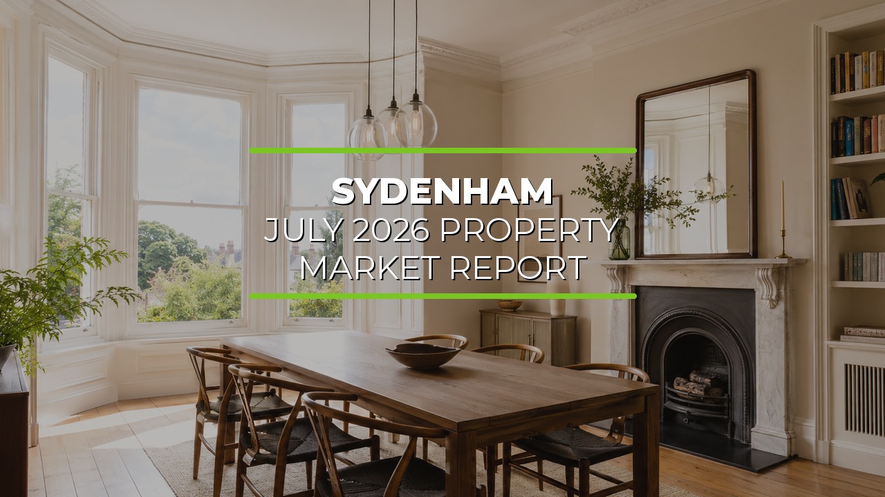 Bright elegant dining room with large bay windows filling the space with natural light. Wooden dining table with chairs sits beneath pendant lights. Decorative fireplace with mirror above, built-in shelves with books and décor, and indoor plants add warmth and character. Overlaid text reads ‘Sydenham July 2026 Property Market Report.’
