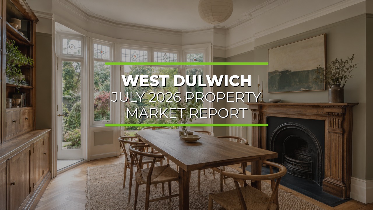 Well-lit dining room with large bay windows overlooking a garden. Wooden dining table with chairs sits at the center. Decorative fireplace with mantel and painting above adds elegance, while built-in wooden cabinetry lines one wall. Neutral tones and natural light enhance the traditional décor. Overlaid text reads ‘West Dulwich July 2026 Property Market Report.’