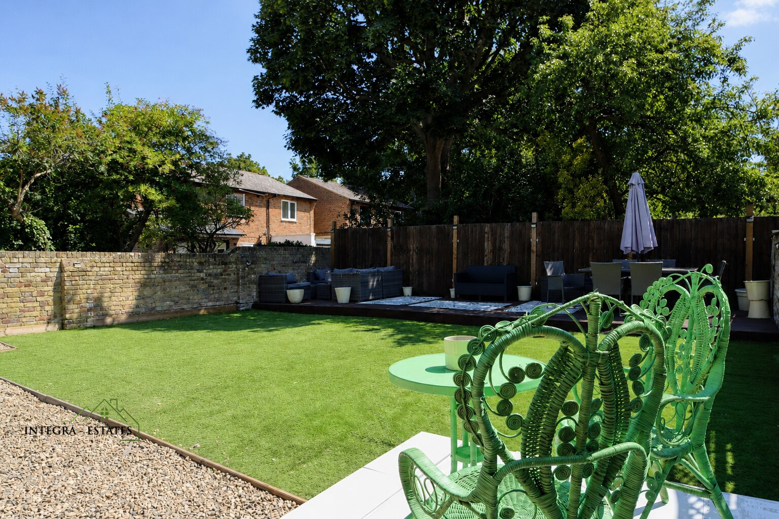 Large private rear garden with seating area, astro turf lawn and decking area to the rear.