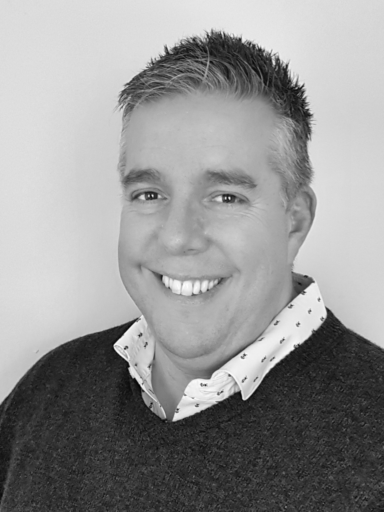 A black and white picture of Thomas Bailey the Director of Integra-Estates happy, big smile headshot image